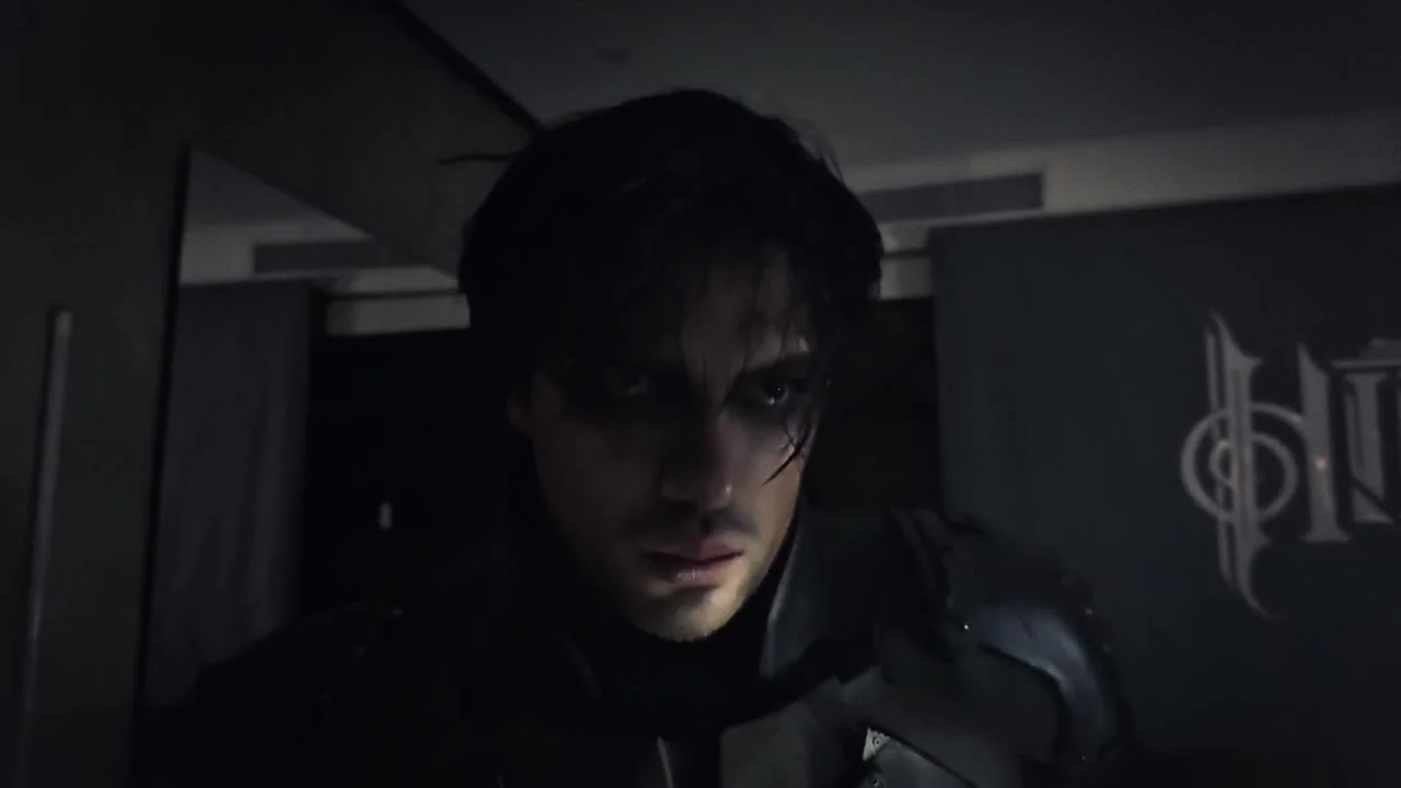 Edd without the mask, in war paint, looking at the camera in his studio
