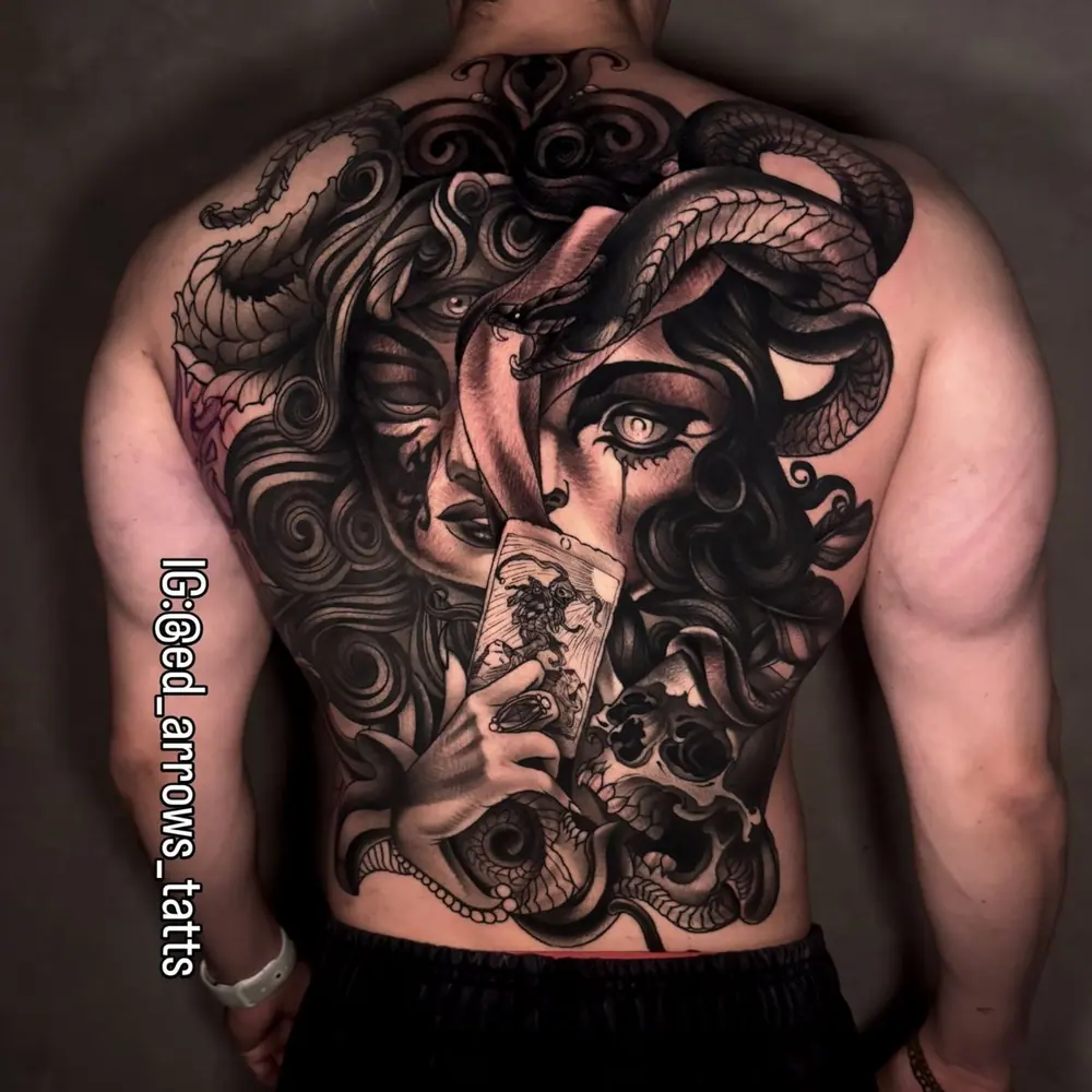 Full-back black and grey tattoo: a witch with snakes in her hair holding a tarot card
